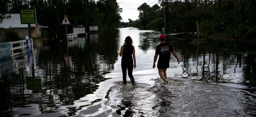People survey the damage and flooding in Steinhatchee, Florida, on Aug. 30, 2023, after Hurricane Idalia passed through the area.