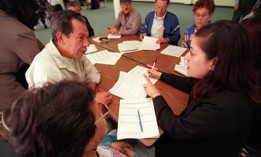 A county welfare official works with TANF recipients in a training session on improving job-seeking skills.