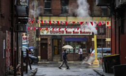 A pedestrian walks through the Chinatown neighborhood of Boston. The city is working to overhaul its zoning code in an effort to build more equitable and sustainable communities. 