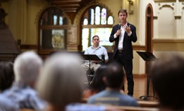 Denver Mayor Mike Johnston discusses the city's challenges with homelessness at town hall meeting in August. With the help of geographic information systems, or GIS, Johnston is planning to develop microshelter communities for people experiencing homelessness on publicly owned land. 