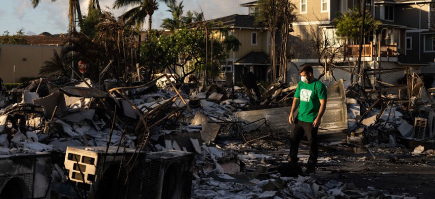 A Mercy Worldwide volunteer makes damage assessment of charred apartment complex in the aftermath of a wildfire in Lahaina, western Maui, Hawaii on Aug. 12, 2023. 
