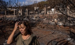 Val Casco looks out onto the backyard of her home, which was destroyed in the Aug. 8 wildfires in Lahaina, Hawaii. Experts warn that without careful strategy, high housing costs could prevent locals from returning to their neighborhoods. 
