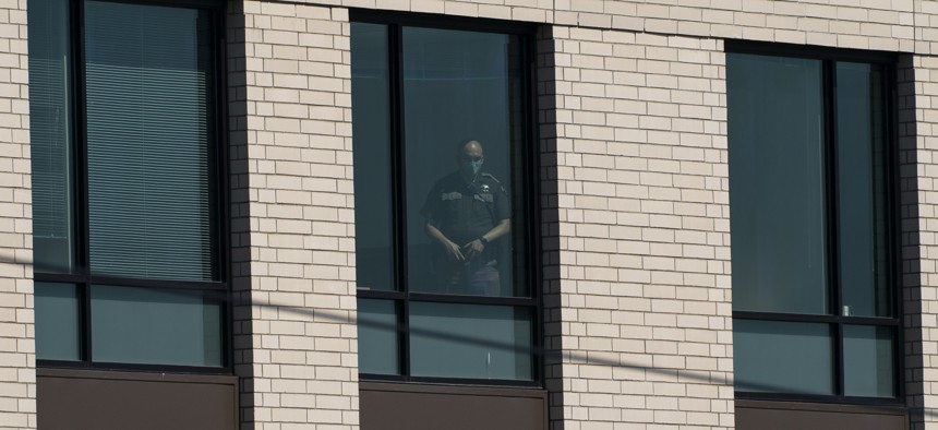 An officer watches from the King County Juvenile Detention building in 2020.