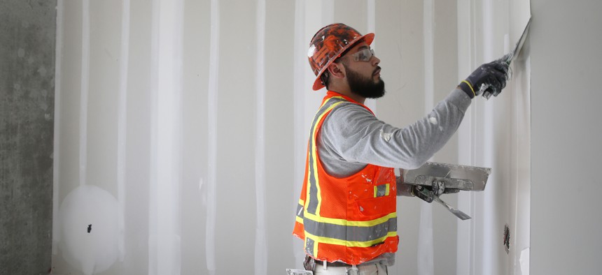 Alonso Gutierrez prepares an apartment for a final coat of paint in a San Francisco apartment building under construction in 2018. 