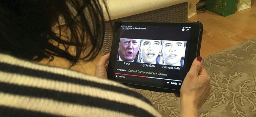 A woman in Washington, D.C., views a manipulated video on Jan. 24, 2019, that changes what is said by former President Donald Trump and former President Barack Obama, illustrating how deepfake technology can deceive viewers. Deepfakes could become a regular part of election advertising unless legislation passes to regulate fake video and audio.