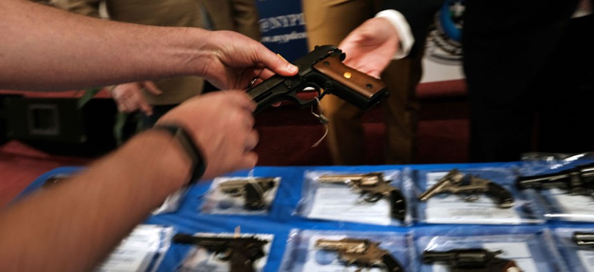 Guns are displayed on a table during a gun buy-back event at a church in Staten Island on April 24, 2021 in New York City. The New York Police Department, the district attorney and others organized the event as gun arrests have increased throughout the year.