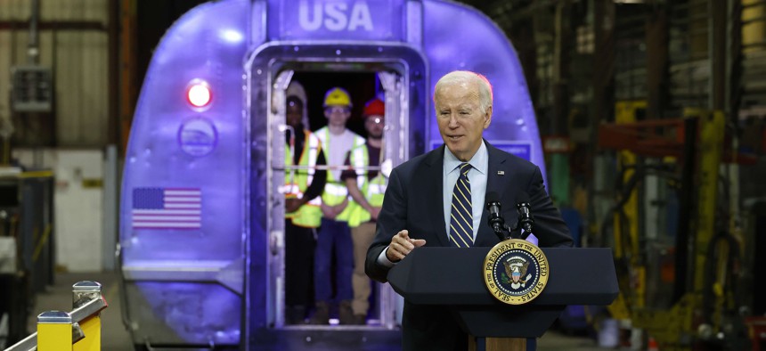 U.S. President Joe Biden announces more than $16 billion in new funding for rail projects on the Northeast Corridor while surrounded by trains inside the Amtrak Bear Heavy Maintenance Facility on Monday.