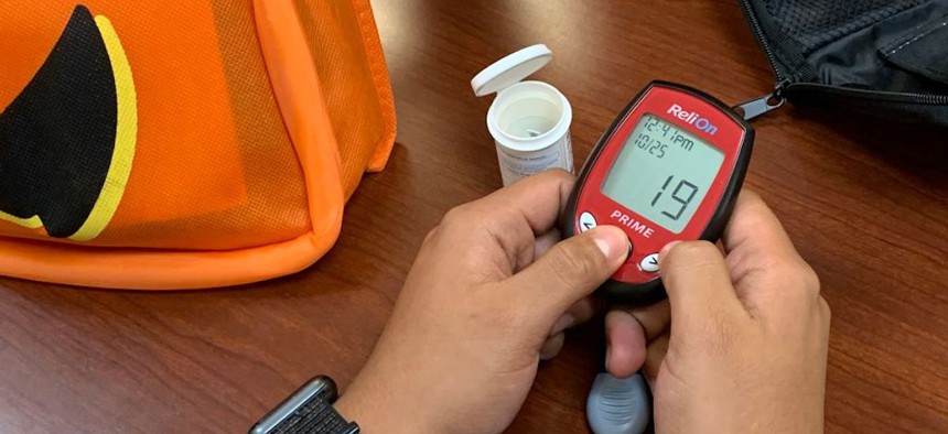 A migrant without legal permanent status learns how to use a glucometer at Children's National Hospital in Washington, D.C., on Oct. 25, 2019. A group of health care providers established a health clinic for children, particularly those with diabetes, who may not otherwise have access to health care due to their immigration status