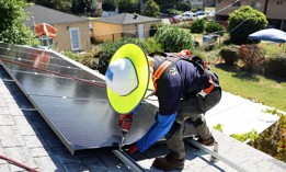 No-cost solar panels are installed on the rooftop of a low-income household in California. 