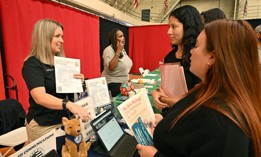 Job seekers speak with employers during a career fair for open job positions at the City of Los Angeles on Nov. 2, 2023.