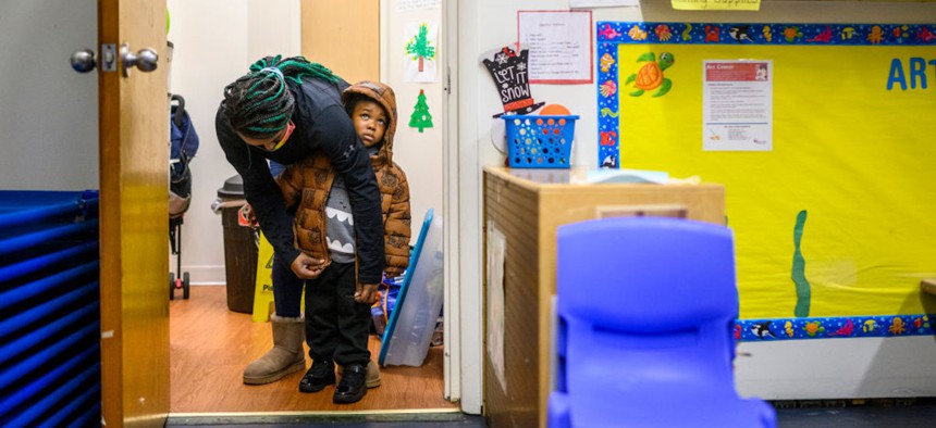 A teacher zips up the coat of a child before recess at Little Flowers Early Childhood and Development Center in the Sandtown-Winchester neighborhood of Baltimore, Maryland on Jan. 12, 2021.