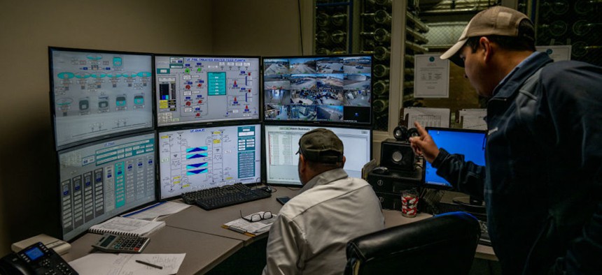 Employees monitor systems in the operating control room at the Roberto Gonzales Regional Water Treatment Plant on Jan. 26, 2023 in Eagle Pass, Texas.