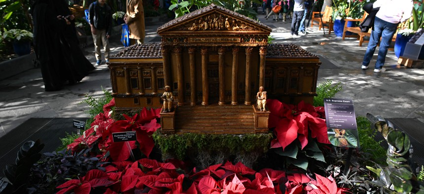 A model of the U.S. Supreme Court in poinsettias are displayed at the U.S. Botanic Garden in Washington, D.C. 
