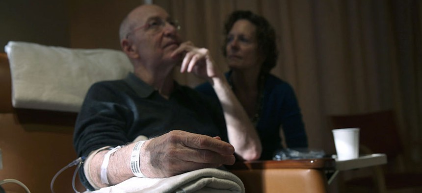 Youssef Cohen, then 68, sits while undergoing cancer treatment as his wife, Lindsay Wright, looks on, on March 17, 2016 in New York City. Cohen, an advocate for medical aid in dying, lived in New York where the practice is illegal. He died in 2021. 