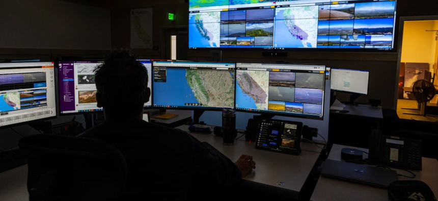 Computer screens depict views of wildfire camera systems throughout the state of California at the Southern California Geographic Area Coordination Center on Aug. 9, 2023, in Moreno Valley, California. The agency is using AI to help monitor the camera systems.