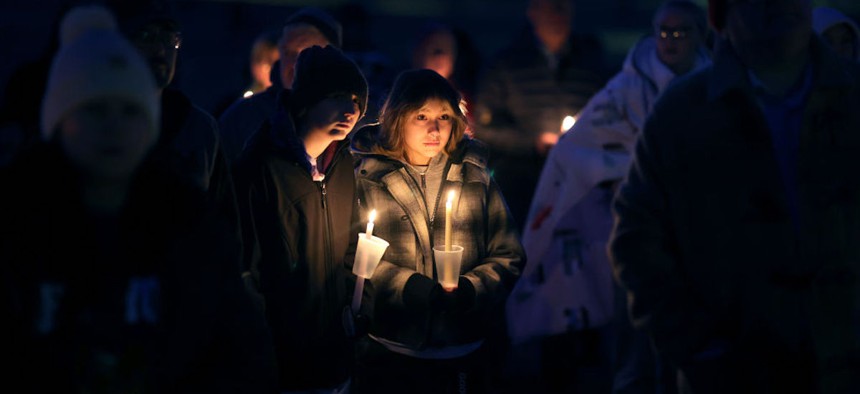 Community members gather in Wiese park for a candlelight vigil following the morning shooting at the Perry Middle School and High School complex on Jan. 04, 2024, in Perry, Iowa. A 17-year-old student identified by authorities as Dylan Butler opened fire at the school on the first day back from the winter break, killing a student and wounding five others.