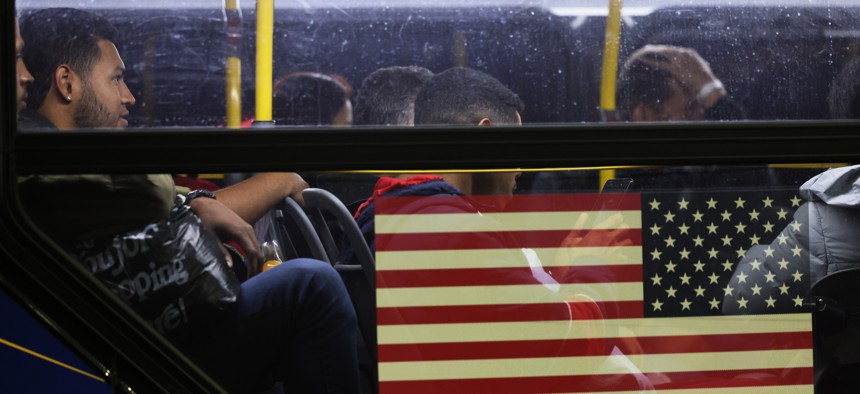 Asylum seekers board a bus en route to a shelter in New York City.
