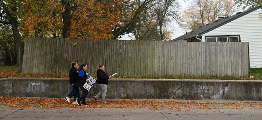 Volunteers canvass a neighborhood to collect signatures on a petition to get paid sick time for all employees working in the state of Nebraska. The goal is to have Nebraskans vote on the initiative next year on the November 2024 ballot. 