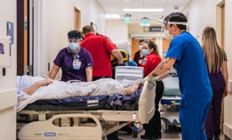 Emergency Room nurses and EMTs tend to patients in hallways at the Houston Methodist The Woodlands Hospital on Aug. 18, 2021, in Houston, Texas.
