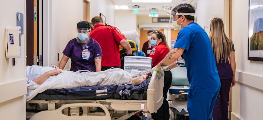 Emergency Room nurses and EMTs tend to patients in hallways at the Houston Methodist The Woodlands Hospital on Aug. 18, 2021, in Houston, Texas.
