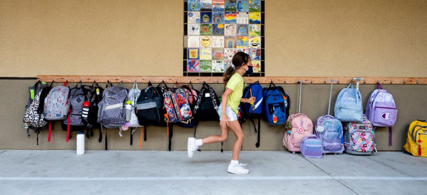 A student rushes to her classroom for the first day of class at Laguna Niguel Elementary School in Laguna Niguel, California, on Aug.17, 2021.