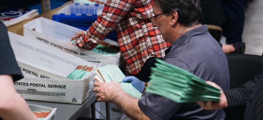 Election workers sort mail in ballots that were dropped off at polling locations to then be sorted at the Maricopa County Tabulation and Election Center on Election Day on Nov. 8, 2022, in Phoenix, Arizona. 