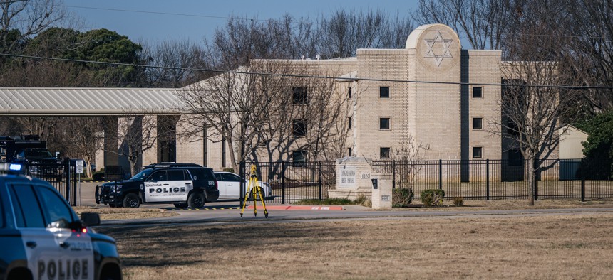 Law enforcement vehicles sit in front of the Congregation Beth Israel synagogue on January 16, 2022 in Colleyville, Texas. 