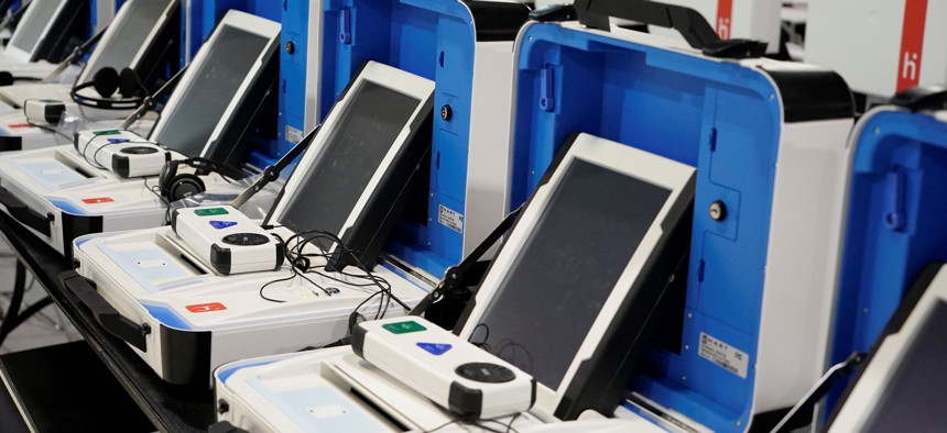 New voting machines are shown at the Harris County Election Technology Center, March 24, 2021, in Houston. A ballot is printed and inserted into the separate machine that counts the ballot and then deposits it in the ballot box. 