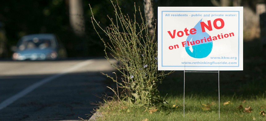 A sign advocating against water flouridation in certain Oregon counties sits on a lawn in Oregon on Oct. 5, 2016.