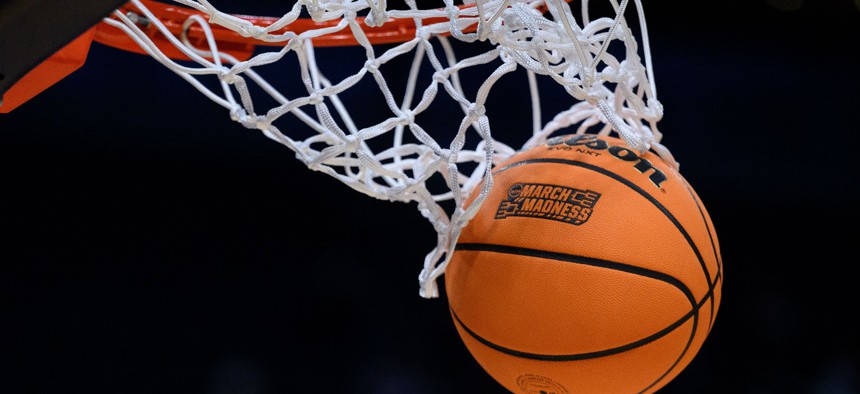 A basketball with March Madness logo falls through the net during the Marquette Golden Eagles versus the Colorado Buffaloes in the second round of the NCAA Division 1 Championship on March 24, 2024, at Gainbridge Fieldhouse in Indianapolis, IN.