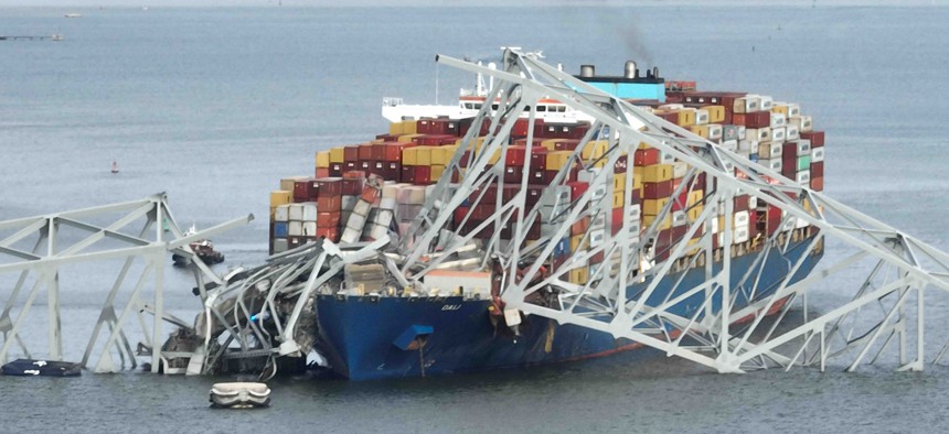 In this aerial image, the steel frame of the Francis Scott Key Bridge sits on top of a container ship after the bridge collapsed, Baltimore, Maryland, on March 26, 2024. 