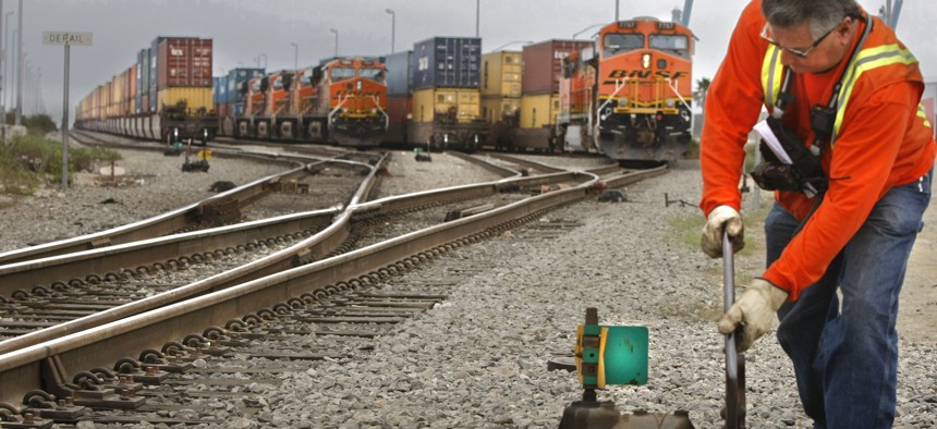 Conductor George Gutierrez throws a switch to put an loaded container train on the eastbound main line out of the Port of Long Beach, California.