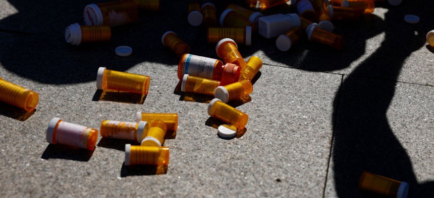 Pill bottles from a piñata are scattered on the sidewalk during a protest against the price of prescription drug costs in front of the U.S. Department of Health and Human Services building on October 06, 2022, in Washington, DC. 