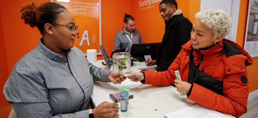 Customer Elise Swopes makes a purchase at Sunnyside Cannabis Dispensary on January 1, 2020 in Chicago, Illinois. Nearly half of Americans live in a state that allows legal access to recreational marijuana. 