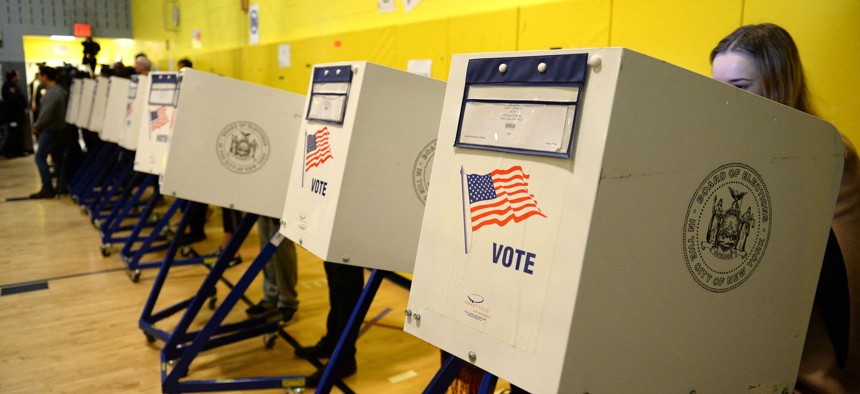People vote at a polling station in a school gymnasium in New York.