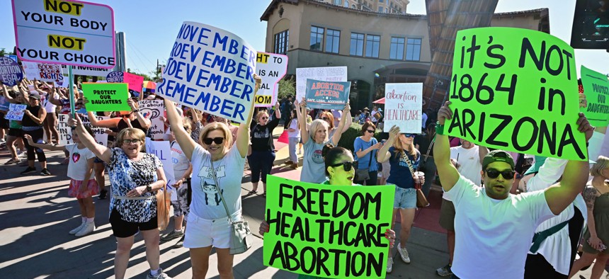 Pro-abortion rights demonstrators rally in Scottsdale, Arizona on April 15, 2024, after the state's top court in Arizona ruled a 160-year-old near total ban on abortion is enforceable.