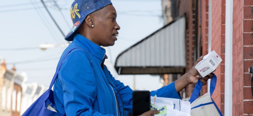 Marsella Elie, a canvasser for the community organization Philly Counts, gives out Narcan, a drug that can reverse an opioid overdose, to a North Philadelphia resident as part of Philadelphia’s door-knocking campaign in neighborhoods heavily affected by the opioid crisis