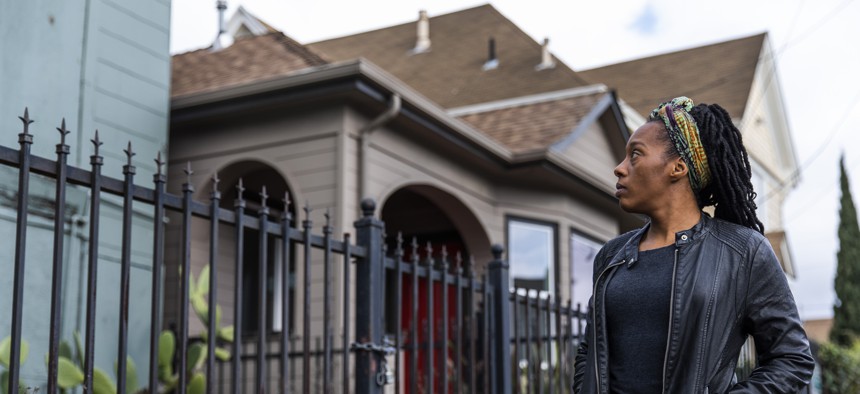 Moms 4 Housing activist Dominique Walker surveys a vacant home located along the same street where she and other homeless or insecurely housed mothers took over a vacant home, in Oakland, California on January 28, 2020, in a bold, high-profile protest against homelessness. 