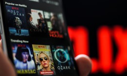 The Netflix application is seen on an Apple iPhone.