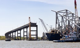 The bow of the Dali cargo ship and the collapsed Francis Scott Key Bridge sit in the water in the Patapsco River in Baltimore.