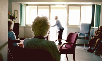 An elderly women sits in a nursing home, May 25, 2004.