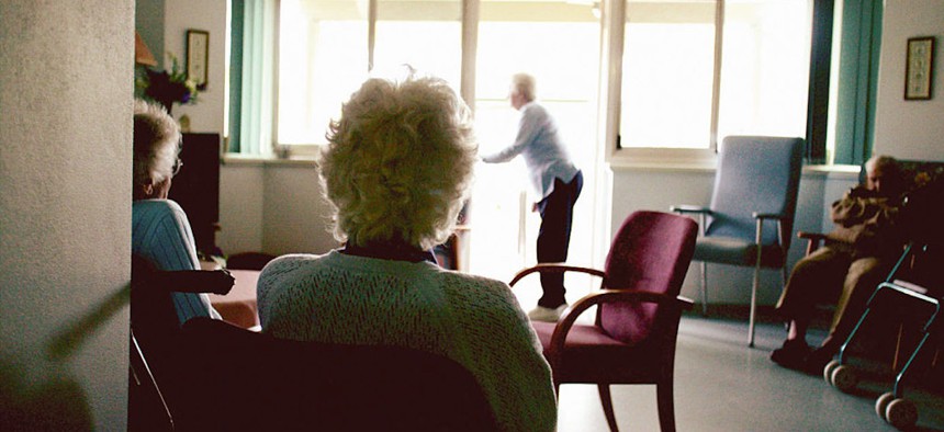 An elderly women sits in a nursing home, May 25, 2004.