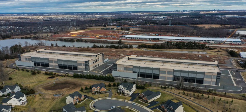 On what was recently farmland, Amazon data centers have been built as close as 50 feet from residential houses in the Loudoun Meadows neighborhood on January 20, 2023, in Aldie, VA. A Microsoft data center is under construction in at top right. 