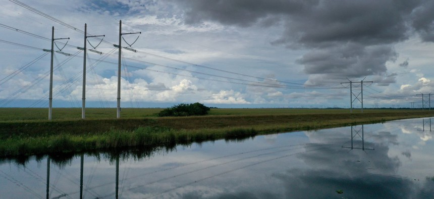 Electric power lines are attached to the transmission tower along the power grid on September 28, 2023 in the Everglades, Florida. 