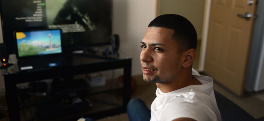  Jonathan Bonilla, then 20, sits down in Massachusetts' first transitioning home for young adults transferring out of foster care on December 19, 2013.