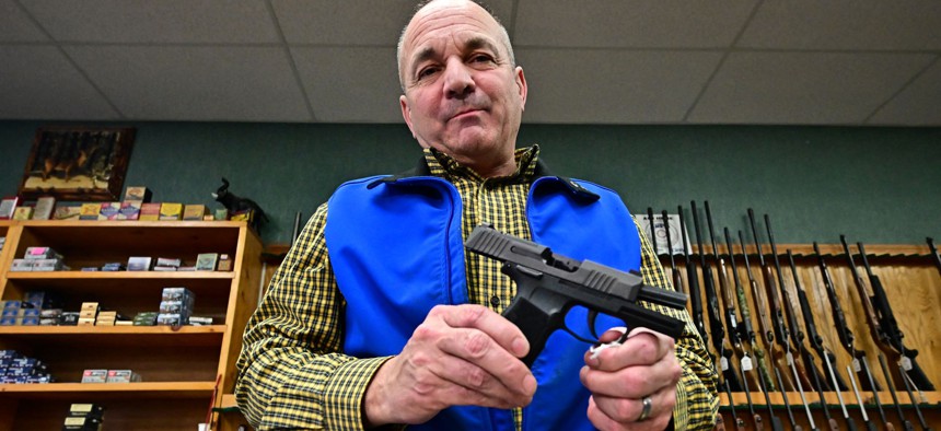 Patrick Jones, Shasta County supervisor and gun shop owner, displays a Sig Sauer Pistol on February 24, 2024 in Redding in Northern California's Shasta County. 