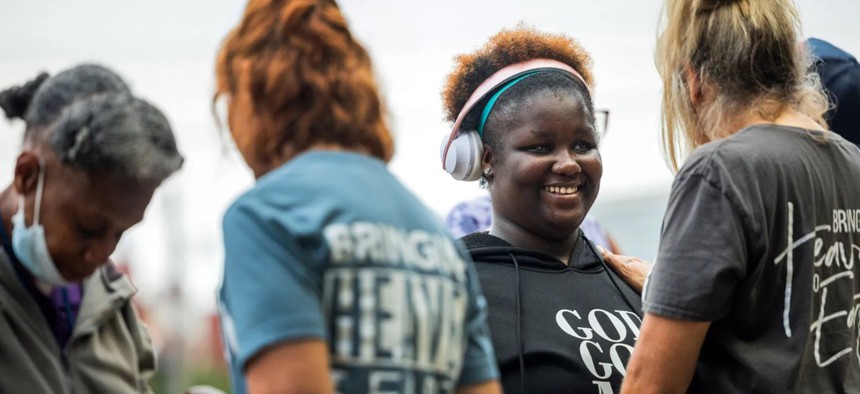 Danielle Stephen, 20, participates in a Christian service May 8 in Houston's Montrose neighborhood. Stephen, who was kicked off campus and into the streets as a high school student, attended the outdoor service to support people struggling with homelessness. 