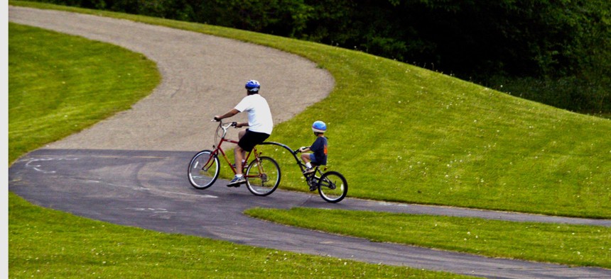 A biker and one-half on a bike and one-half make it up a path in Phalen-Keller Regional Park in St. Paul.