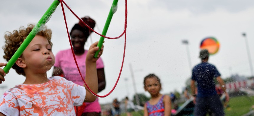 Children play as residents, community members and locals enjoy a pop-up beach in North Philadelphia. Over the past decade, states have worked steadily to recognize the roles of grandparents and other extended loved ones, now known collectively as kinship caregivers, in raising children who otherwise might be in foster care.