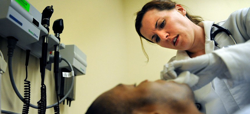 Family Nurse Practitioner, Amy Quinone examines Medicaid patient, Thomas Crippen at Denver Health's Adult Urgent Care Clinic. 